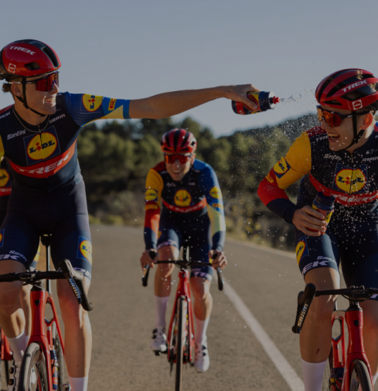 Lidl Trek riders celebrating on a sunlit training road